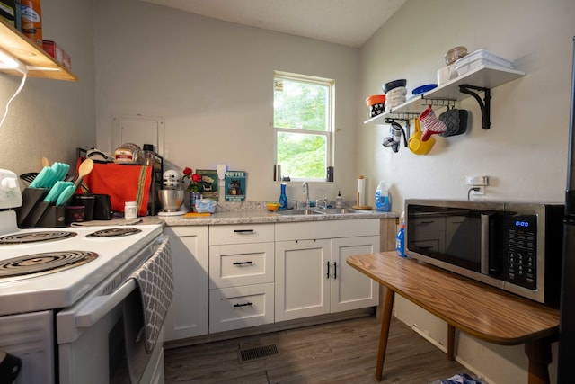 602 S Elm St, Villa Grove, IL 61956 - kitchen featuring white electric range oven, stainless steel microwave, wood finished floors, white cabinetry, and light countertops