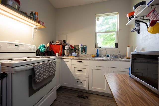 602 S Elm St, Villa Grove, IL 61956 - kitchen with white electric range oven, dark wood-style floors, white cabinets, light countertops, and open shelves