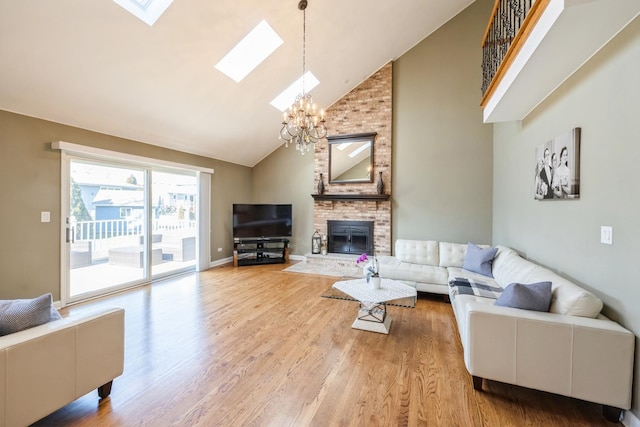 890 Woodcrest Ln, Lemont, IL 60439 - living area featuring high vaulted ceiling, a chandelier, a skylight, a fireplace, and light wood-type flooring