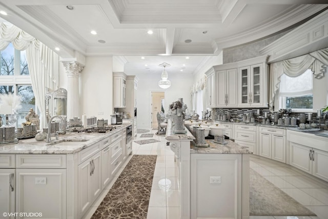2315 N Arlington Heights Rd, Arlington Heights, IL 60004 - kitchen with a sink, a center island, light tile patterned floors, glass insert cabinets, and ornamental molding