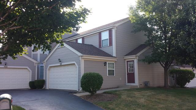 1172 Center Dr, Marengo, IL 60152 - traditional-style house with driveway and an attached garage