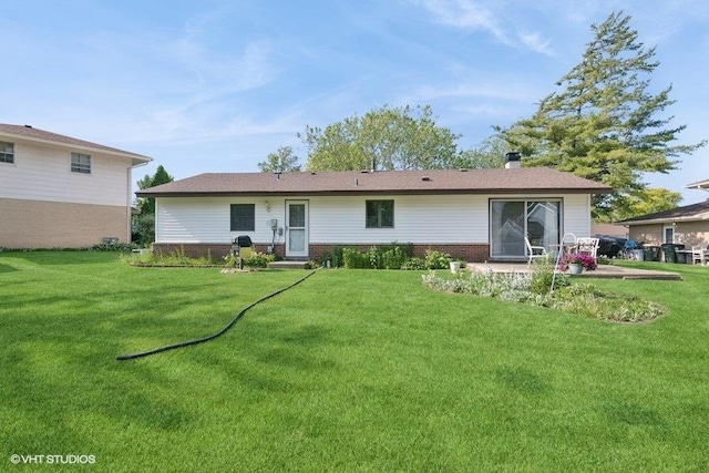 27 Keswick Rd, Elk Grove Village, IL 60007 - rear view of house featuring brick siding and a lawn