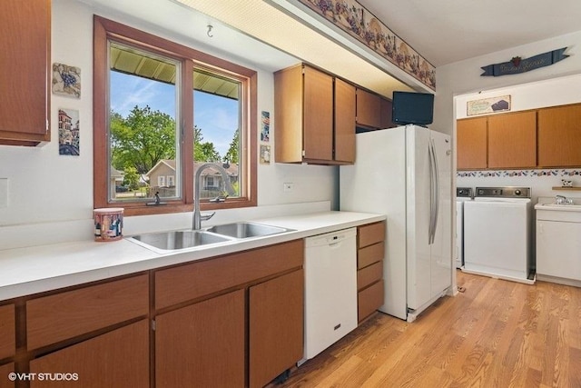 27 Keswick Rd, Elk Grove Village, IL 60007 - kitchen with white appliances, separate washer and dryer, light countertops, light wood-style floors, and brown cabinetry