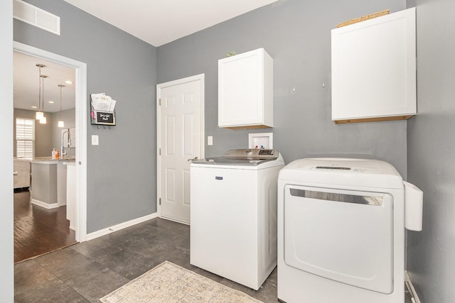14904 S Morgan Ln, Plainfield, IL 60544 - laundry room with cabinet space and washer and clothes dryer