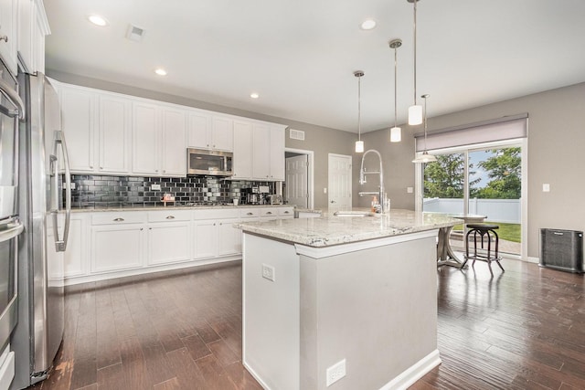 14904 S Morgan Ln, Plainfield, IL 60544 - kitchen featuring appliances with stainless steel finishes, dark wood-style flooring, backsplash, white cabinets, and recessed lighting