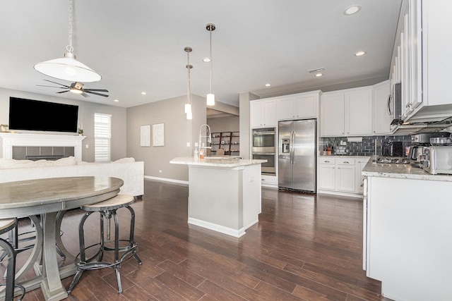 14904 S Morgan Ln, Plainfield, IL 60544 - kitchen with appliances with stainless steel finishes, open floor plan, ceiling fan, dark wood-style flooring, and decorative backsplash