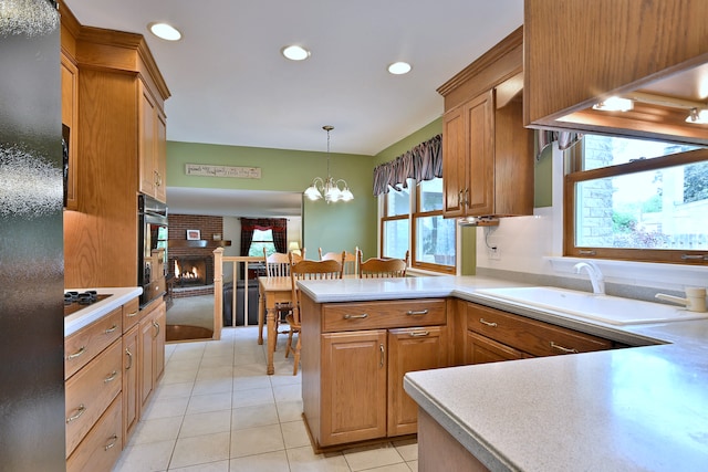 537 S Echo Ln, Palatine, IL 60067 - kitchen featuring stainless steel oven, decorative light fixtures, light tile patterned floors, a peninsula, and brown cabinetry