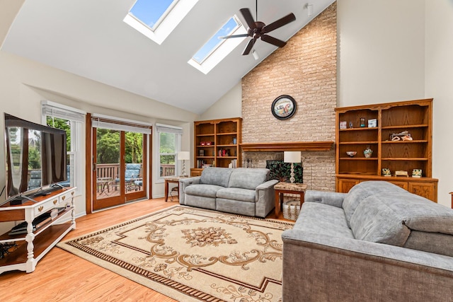 1440 Monarch Cir, Naperville, IL 60564 - living room with high vaulted ceiling, a skylight, a brick fireplace, wood finished floors, and a ceiling fan