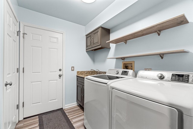 1440 Monarch Cir, Naperville, IL 60564 - laundry area featuring independent washer and dryer, cabinet space, light wood-style floors, and baseboards