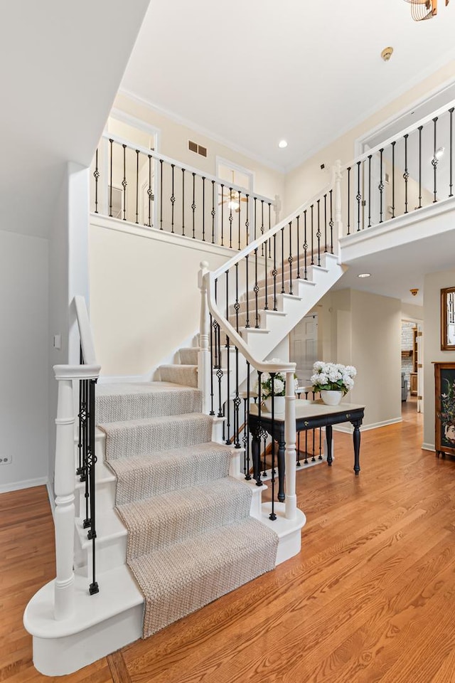 1440 Monarch Cir, Naperville, IL 60564 - stairs featuring baseboards, wood finished floors, a high ceiling, and recessed lighting
