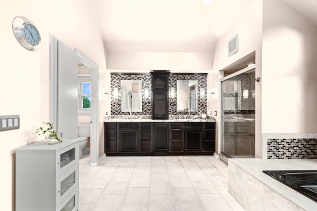 1440 Monarch Cir, Naperville, IL 60564 - bathroom with lofted ceiling, double vanity, toilet, tasteful backsplash, and a garden tub