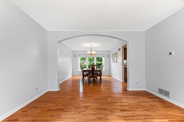 1440 Monarch Cir, Naperville, IL 60564 - dining room featuring arched walkways, a chandelier, and light wood finished floors
