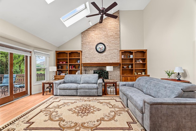 1440 Monarch Cir, Naperville, IL 60564 - living room featuring high vaulted ceiling, a brick fireplace, wood finished floors, a ceiling fan, and a skylight
