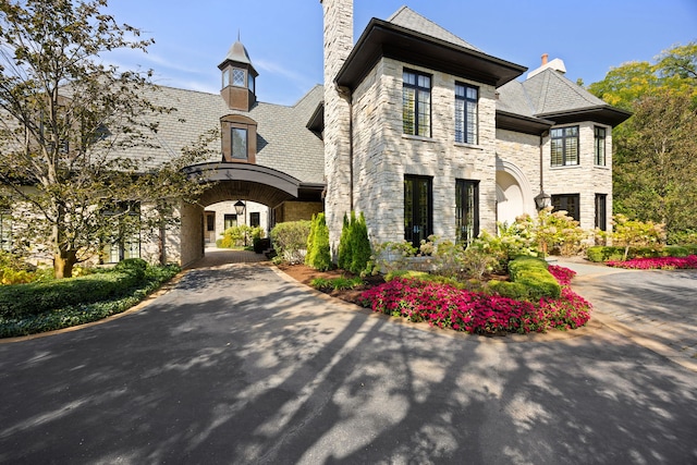 15W120 60th St, Burr Ridge, IL 60527 - view of front of property featuring stone siding and a chimney