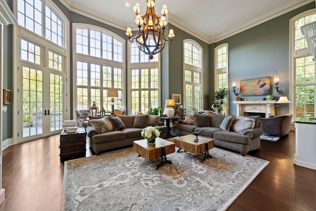 15W120 60th St, Burr Ridge, IL 60527 - living area featuring ornamental molding, dark wood-style flooring, a chandelier, a fireplace, and a towering ceiling