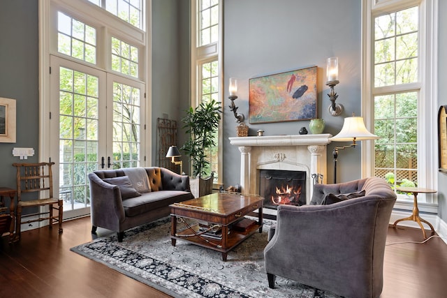 15W120 60th St, Burr Ridge, IL 60527 - living area with a warm lit fireplace, wood finished floors, and a towering ceiling