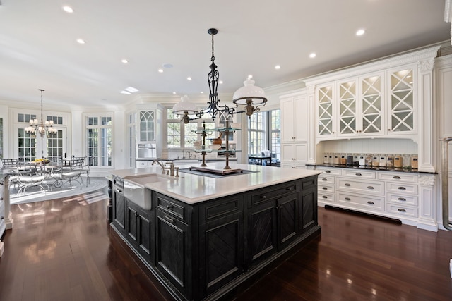 15W120 60th St, Burr Ridge, IL 60527 - kitchen with dark cabinetry, a chandelier, white cabinets, dark wood-style floors, and crown molding
