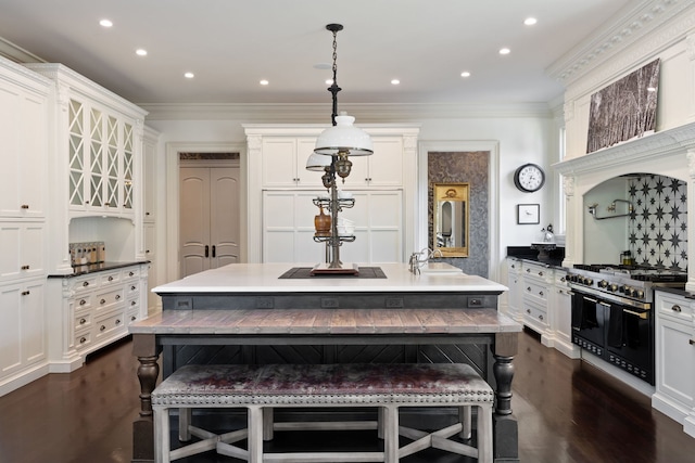 15W120 60th St, Burr Ridge, IL 60527 - kitchen with double oven range, a kitchen bar, white cabinetry, dark wood-type flooring, and ornamental molding