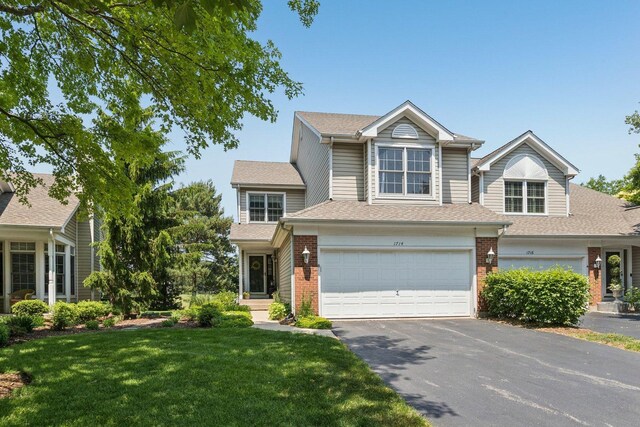 1714 Waverly Cir, Saint Charles, IL 60174 - view of front facade featuring driveway, brick siding, a front yard, a garage, and roof with shingles