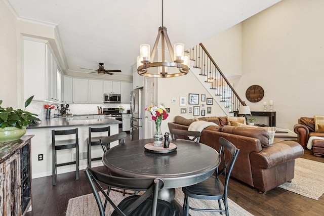 1714 Waverly Cir, Saint Charles, IL 60174 - dining space featuring dark wood finished floors, a ceiling fan, stairway, and a chandelier