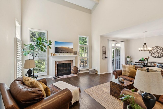 1714 Waverly Cir, Saint Charles, IL 60174 - living room with a brick fireplace, a chandelier, wood finished floors, and a high ceiling