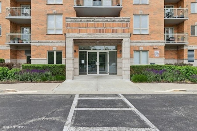 6807 N Milwaukee Ave Unit 708, Niles, IL 60714 - view of apartment building / complex featuring uncovered parking