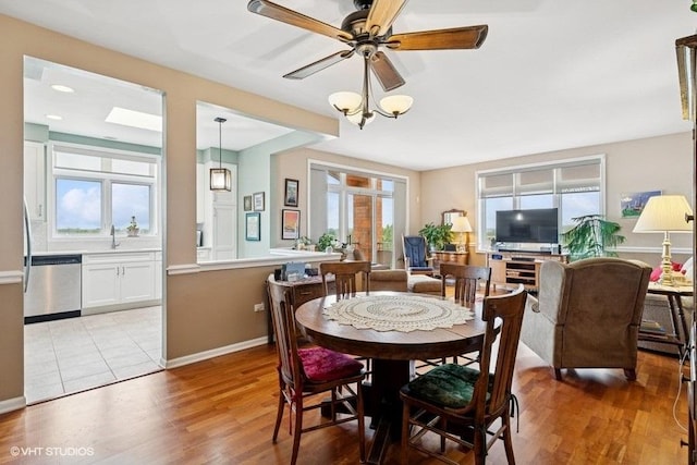 6807 N Milwaukee Ave Unit 708, Niles, IL 60714 - dining space featuring light wood-style flooring, ceiling fan, and baseboards