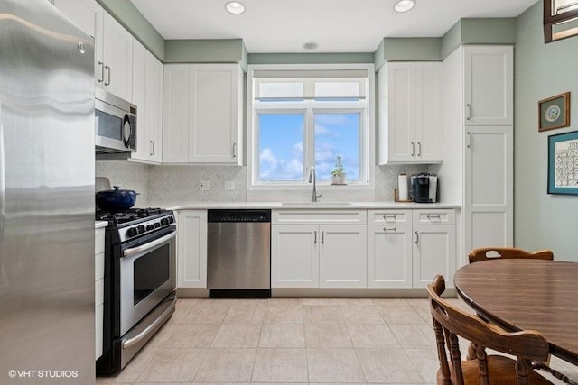 6807 N Milwaukee Ave Unit 708, Niles, IL 60714 - kitchen with stainless steel appliances, a sink, light countertops, backsplash, and recessed lighting