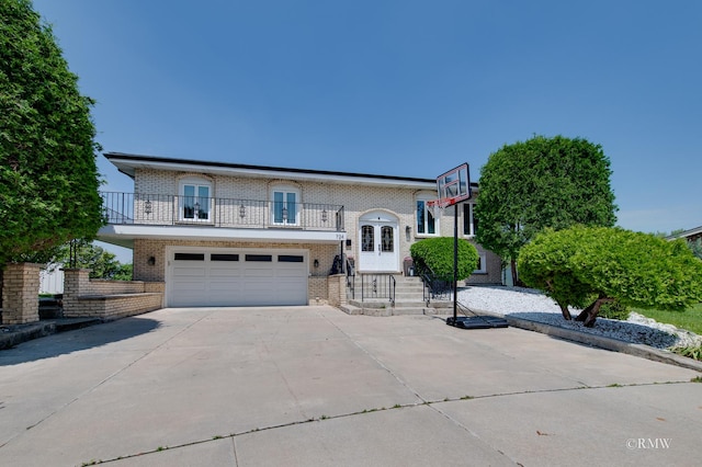 724 N Plamondon Dr, Addison, IL 60101 - bi-level home with brick siding, concrete driveway, a balcony, and an attached garage