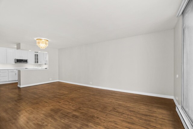 6007 N Sheridan Rd Unit 37H, Chicago, IL 60660 - unfurnished living room featuring a chandelier, dark wood-style floors, baseboard heating, and baseboards