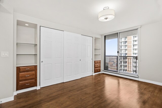 6007 N Sheridan Rd Unit 37H, Chicago, IL 60660 - unfurnished bedroom with dark wood-style floors, access to outside, baseboards, and a closet