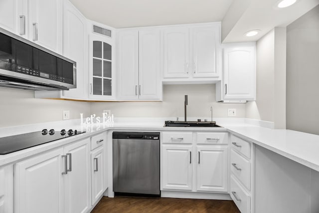 6007 N Sheridan Rd Unit 37H, Chicago, IL 60660 - kitchen featuring stainless steel appliances, a sink, dark wood-type flooring, white cabinetry, and glass insert cabinets