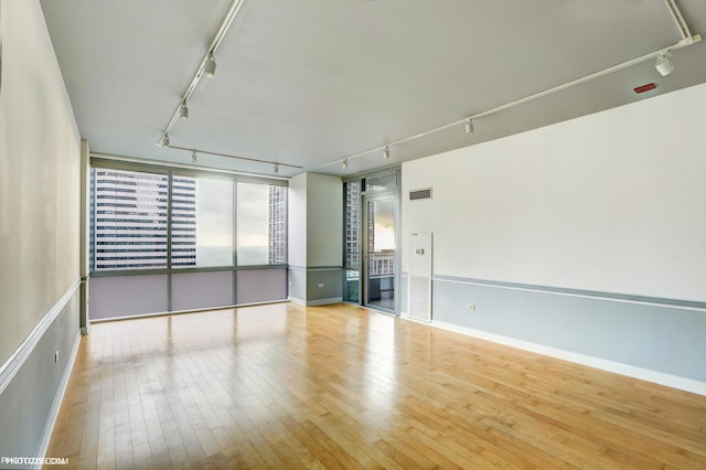 8 E Randolph St Unit 2702, Chicago, IL 60601 - empty room with rail lighting and hardwood / wood-style floors