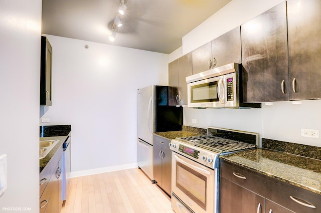 8 E Randolph St Unit 2702, Chicago, IL 60601 - kitchen with stainless steel appliances, dark stone countertops, dark brown cabinets, and light wood-style flooring