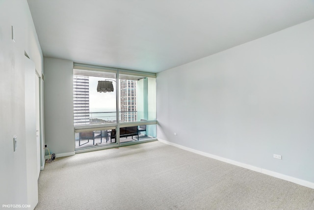8 E Randolph St Unit 2702, Chicago, IL 60601 - carpeted empty room featuring baseboards and expansive windows