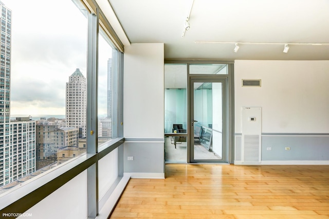 8 E Randolph St Unit 2702, Chicago, IL 60601 - spare room featuring track lighting, hardwood / wood-style flooring, and a city view