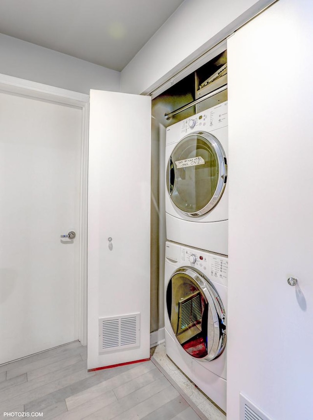 8 E Randolph St Unit 2702, Chicago, IL 60601 - laundry area featuring stacked washer / dryer and wood finished floors