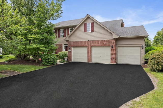 16266 W Mohawk Ct, Lockport, IL 60441 - view of front of house with driveway, brick siding, a garage, and roof with shingles