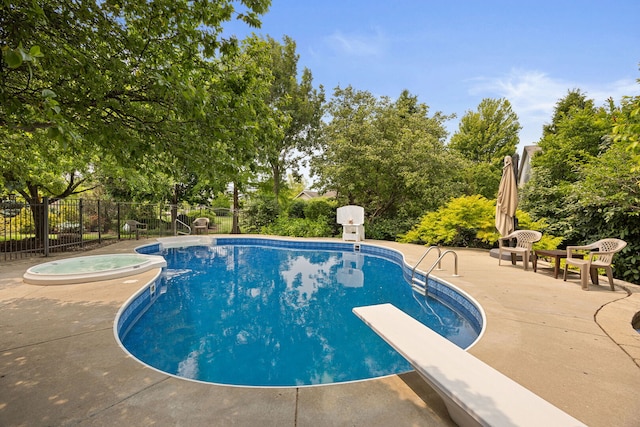 16266 W Mohawk Ct, Lockport, IL 60441 - view of pool featuring an in-ground hot tub, a patio, a diving board, and view of wooded area