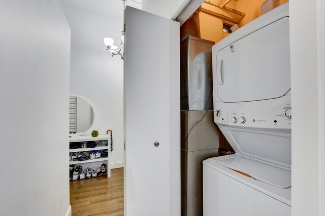 1322 S Wabash Ave Unit 407, Chicago, IL 60605 - washroom featuring stacked washer / dryer and wood finished floors