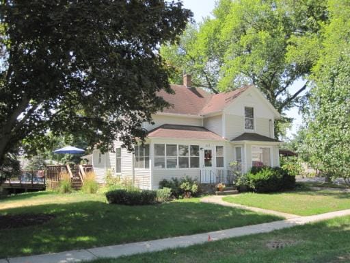 429 W Pierce St, Elburn, IL 60119 - view of front of house featuring a front yard, a wooden deck, and a chimney