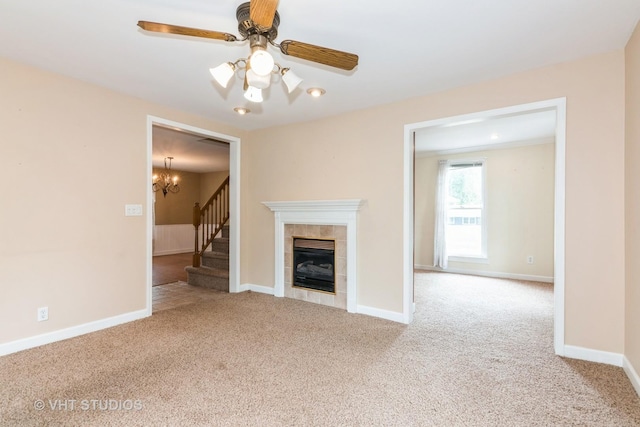 429 W Pierce St, Elburn, IL 60119 - unfurnished living room with carpet floors, a tile fireplace, a chandelier, stairs, and a ceiling fan