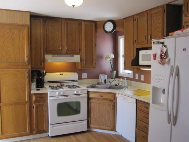 429 W Pierce St, Elburn, IL 60119 - kitchen with white appliances, under cabinet range hood, light countertops, and brown cabinets