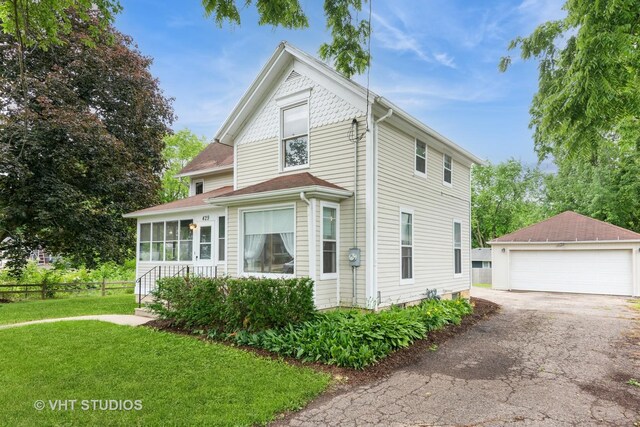 429 W Pierce St, Elburn, IL 60119 - view of front of house with a garage, an outbuilding, and a sunroom