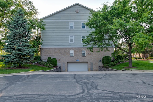 1259 W Lake St Unit 304, Addison, IL 60101 - view of home's exterior featuring a garage and brick siding