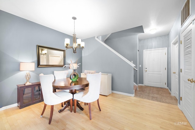 1259 W Lake St Unit 304, Addison, IL 60101 - dining room featuring a chandelier, light wood-style floors, and stairs