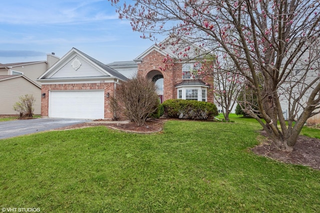 1110 Oakhill Dr, Aurora, IL 60502 - traditional home with driveway, brick siding, a front yard, and a garage