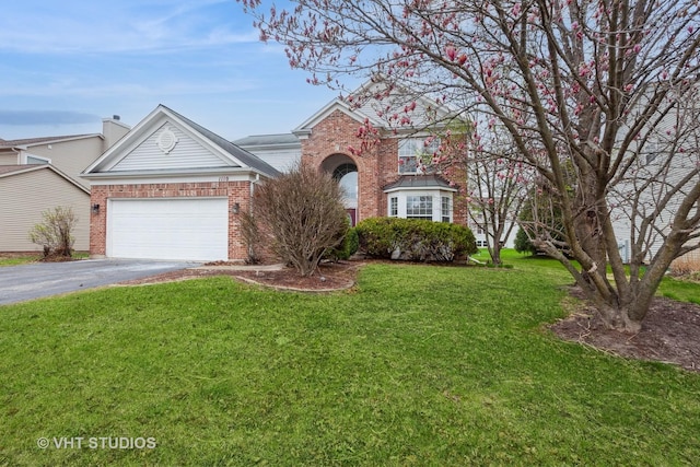 1110 Oakhill Dr, Aurora, IL 60502 - traditional-style home with asphalt driveway, brick siding, a front yard, and an attached garage