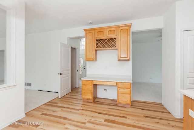 1110 Oakhill Dr, Aurora, IL 60502 - kitchen featuring light brown cabinetry, light wood-type flooring, light countertops, and a desk