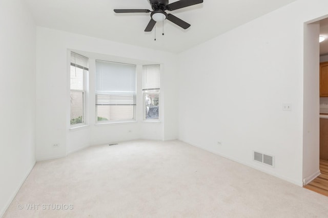 1110 Oakhill Dr, Aurora, IL 60502 - unfurnished room featuring light colored carpet, a ceiling fan, and baseboards